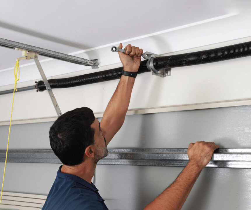 technician working on a garage door