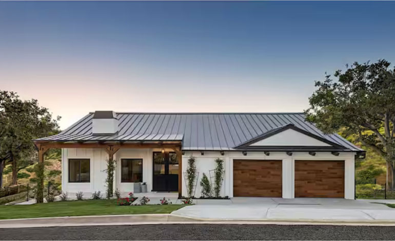 exterior of a white house with wooden garage doors