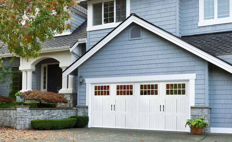 white garage door on a blue house