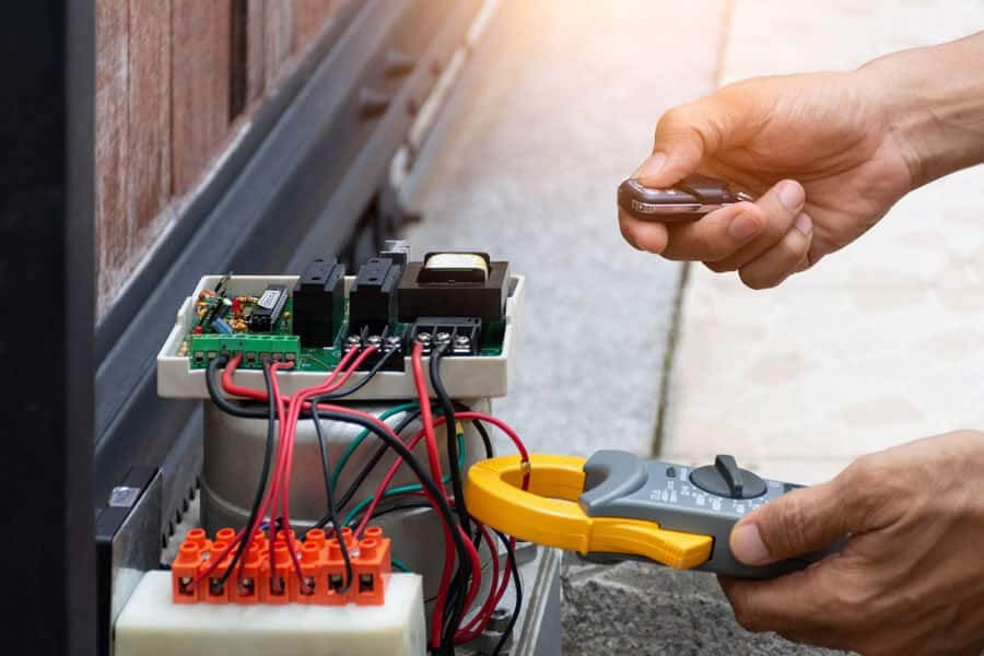 technician repairing a garage door mechanism 