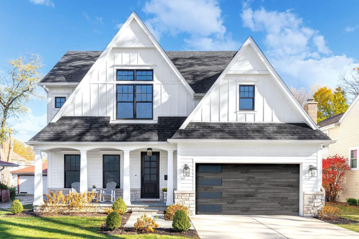exterior of a white house with a black garage door