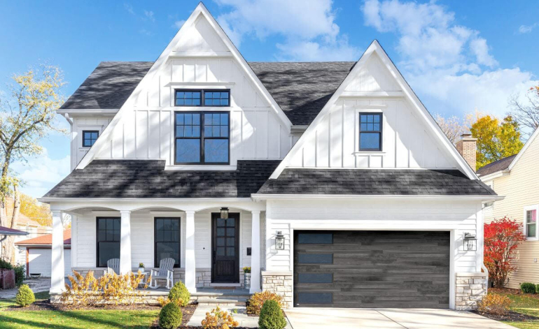 exterior of a white house with dark gray garage doors