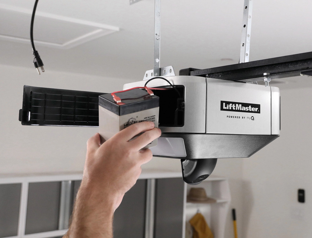 technician working on a garage door opener