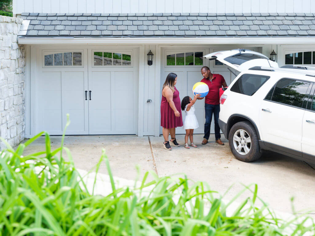 family standing in front of their garage