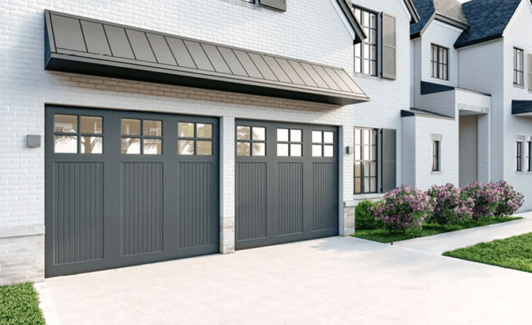 exterior of a white house with dark gray garage doors