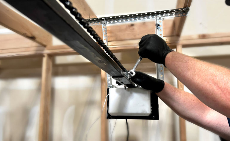 technician doing maintenance on a garage door track