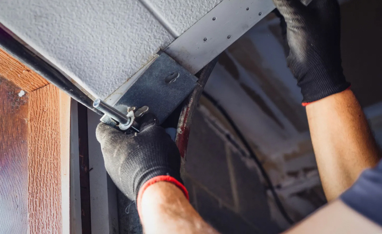 technician manually pulling down a garage door