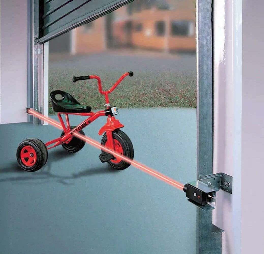 garage door laser being passed by a child's bicycle