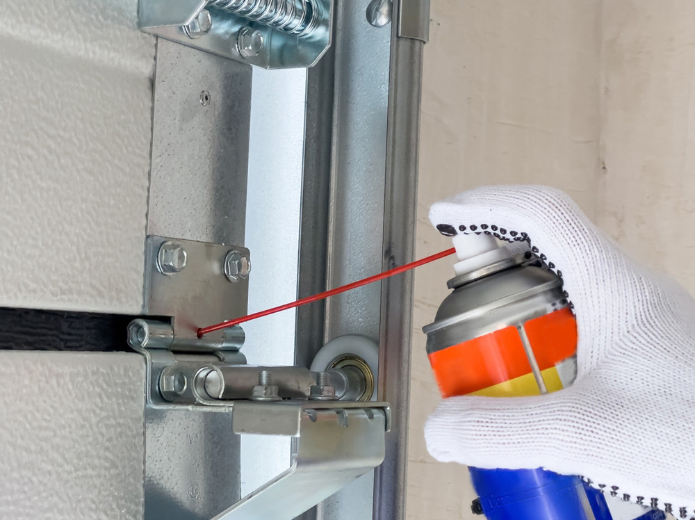 lubricating a garage door track
