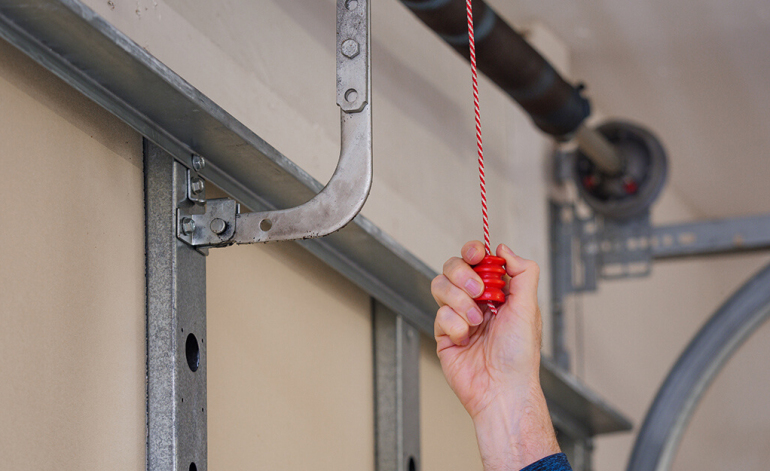 opening a garage door with a red pull-string