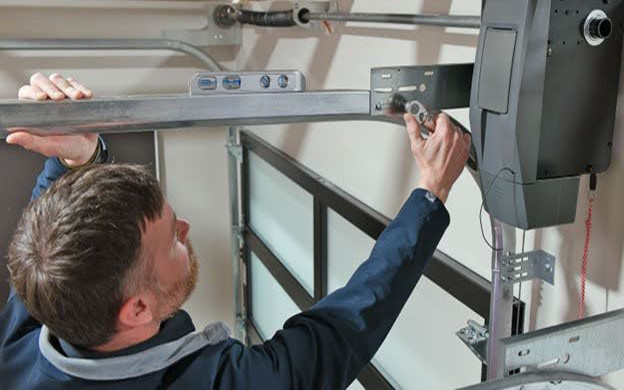 technician tightening a garage door track
