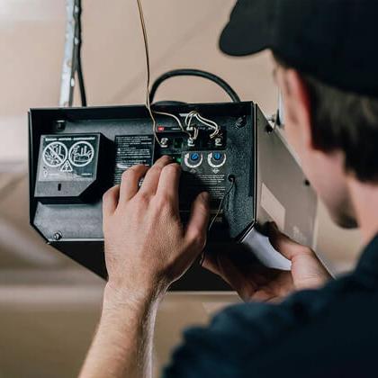 technician inspecting a garage door opener