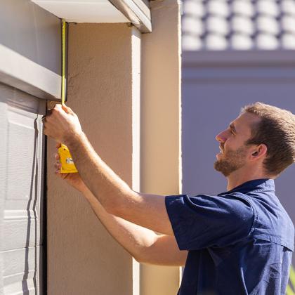technician performing inspection on a garage door