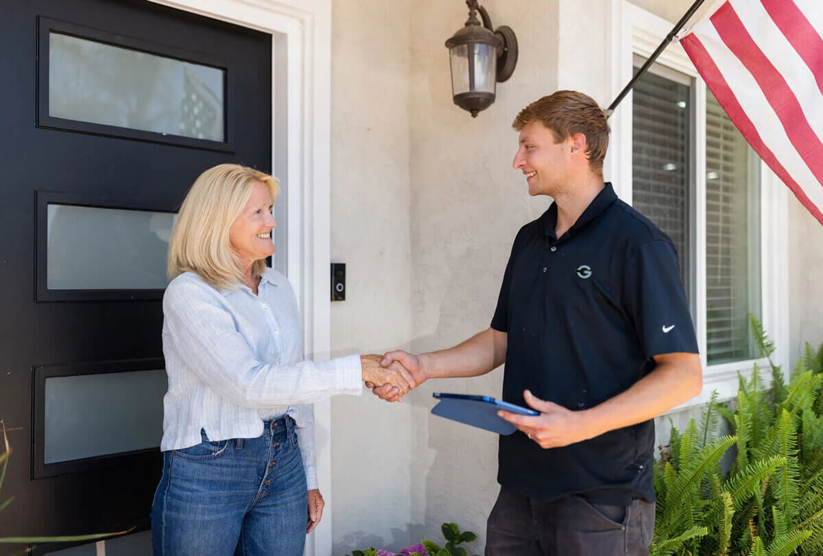 woman shaking hands with a Garage360 technician