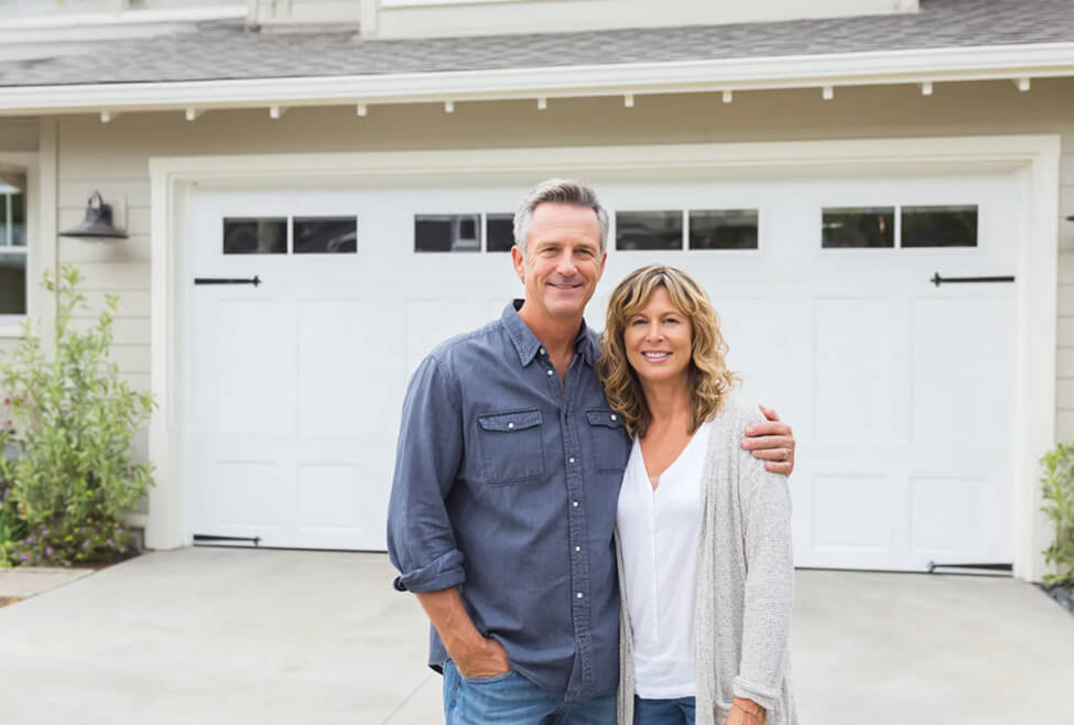 couple in front of a garage