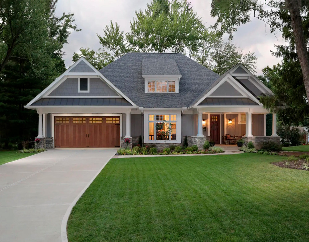 gray house with brown wooden garage door