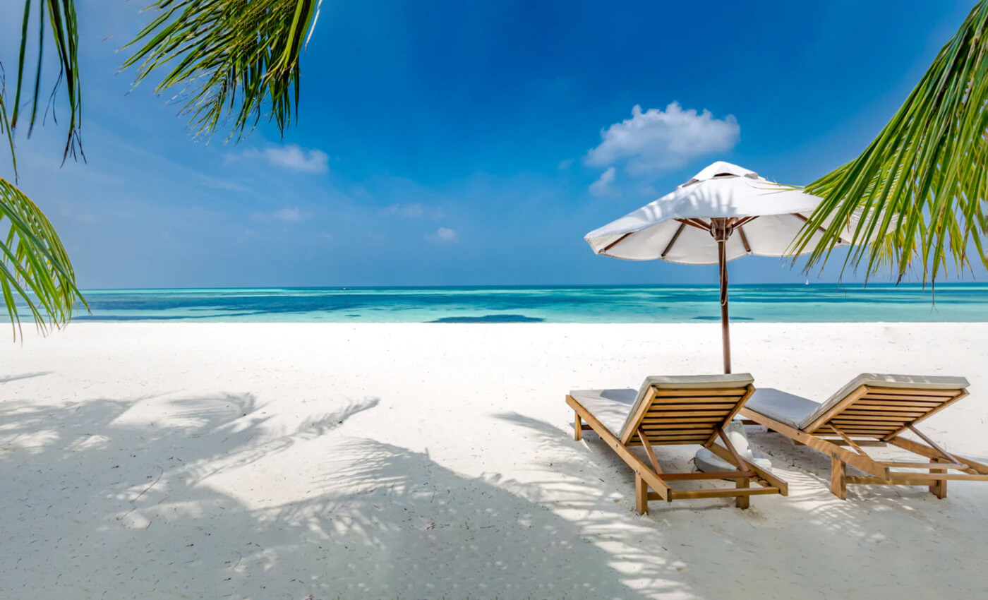 chairs sitting in the sand at the beach